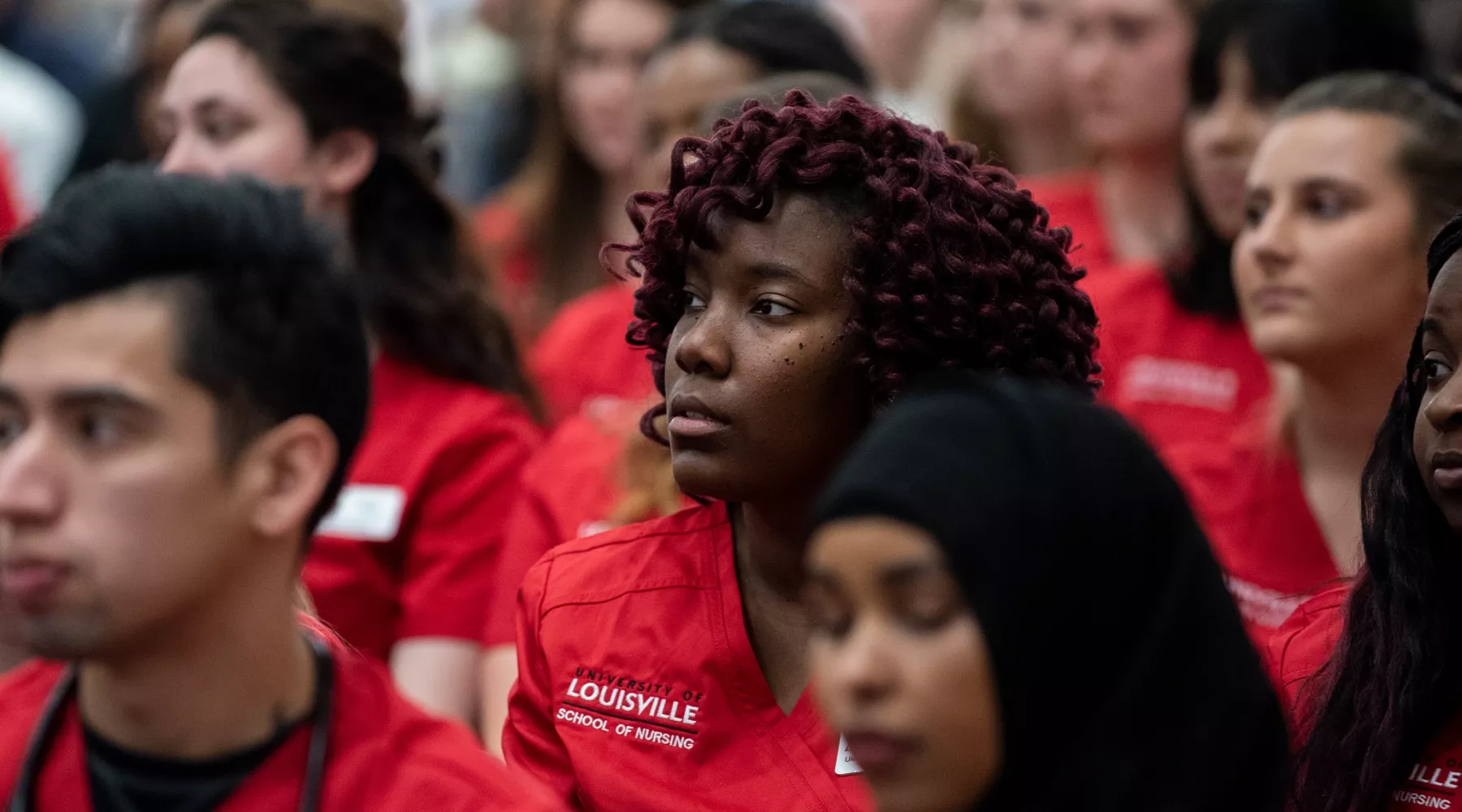 Nursing student listens to speakers at the Nursing Transition Ceremony
