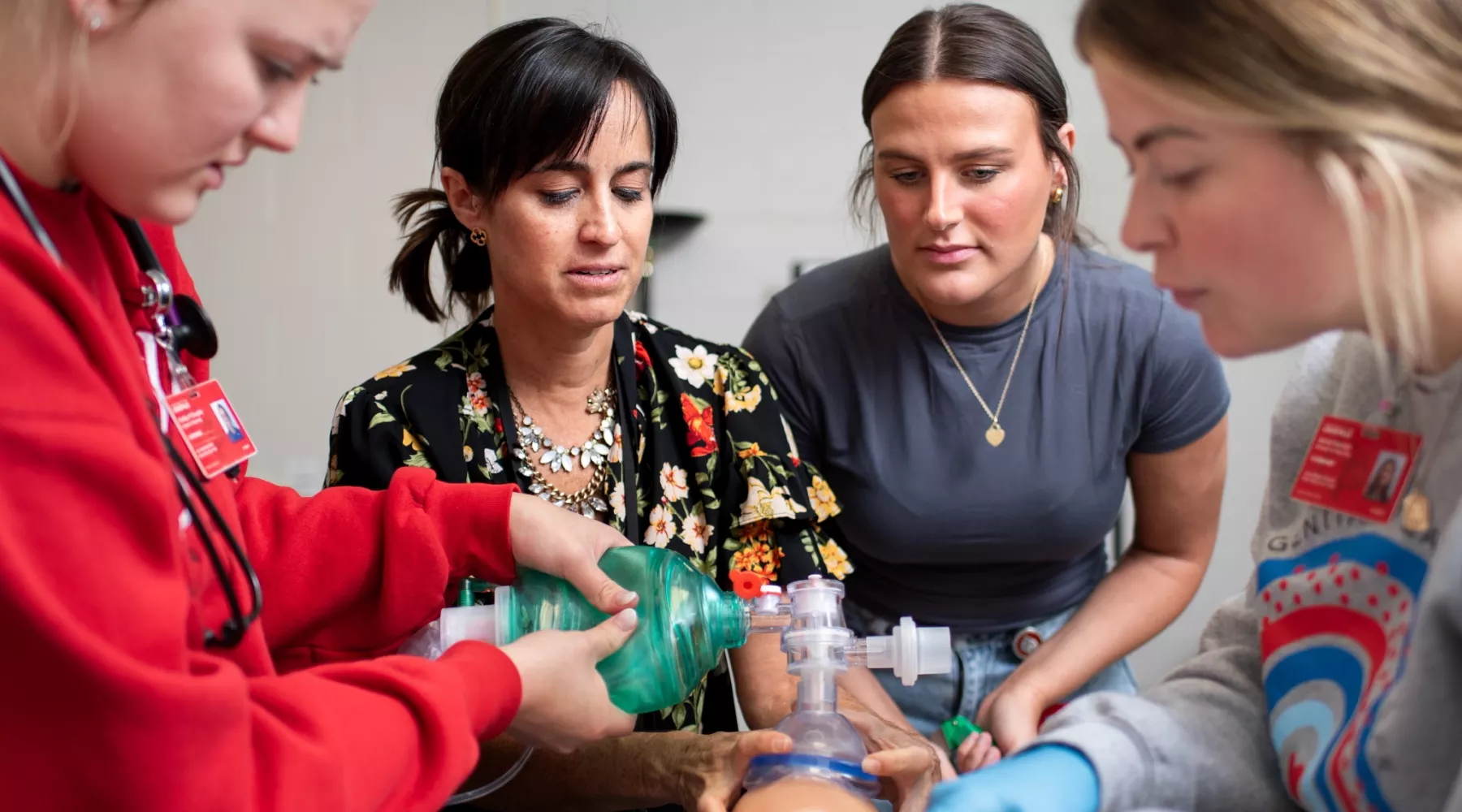 pediatric acute care students practicing intubation on manikin