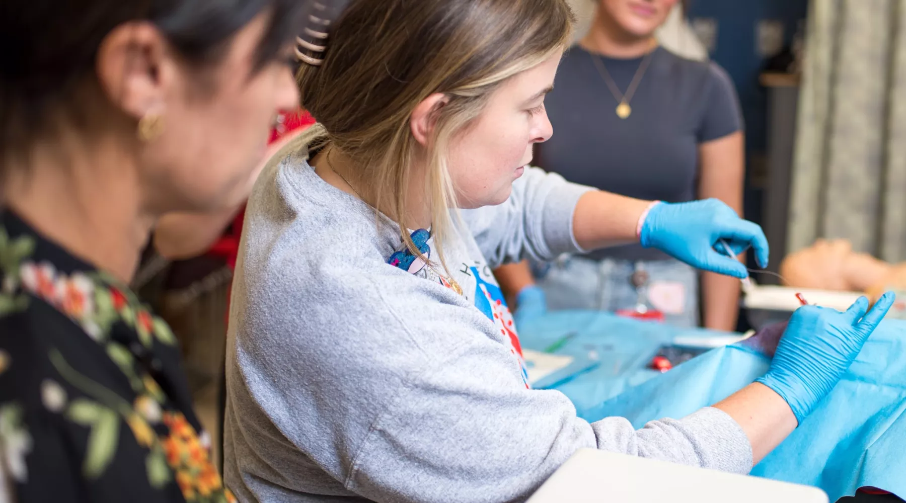 pediatric acute care students practicing intubation on manikin