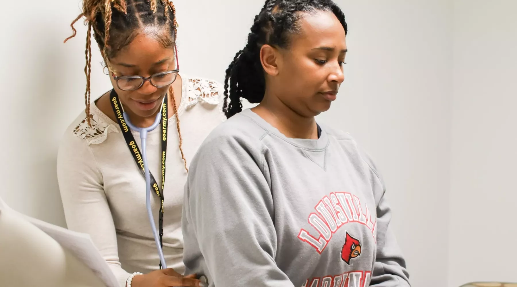 DNP student performs health assessment in a simulated clinic environment.