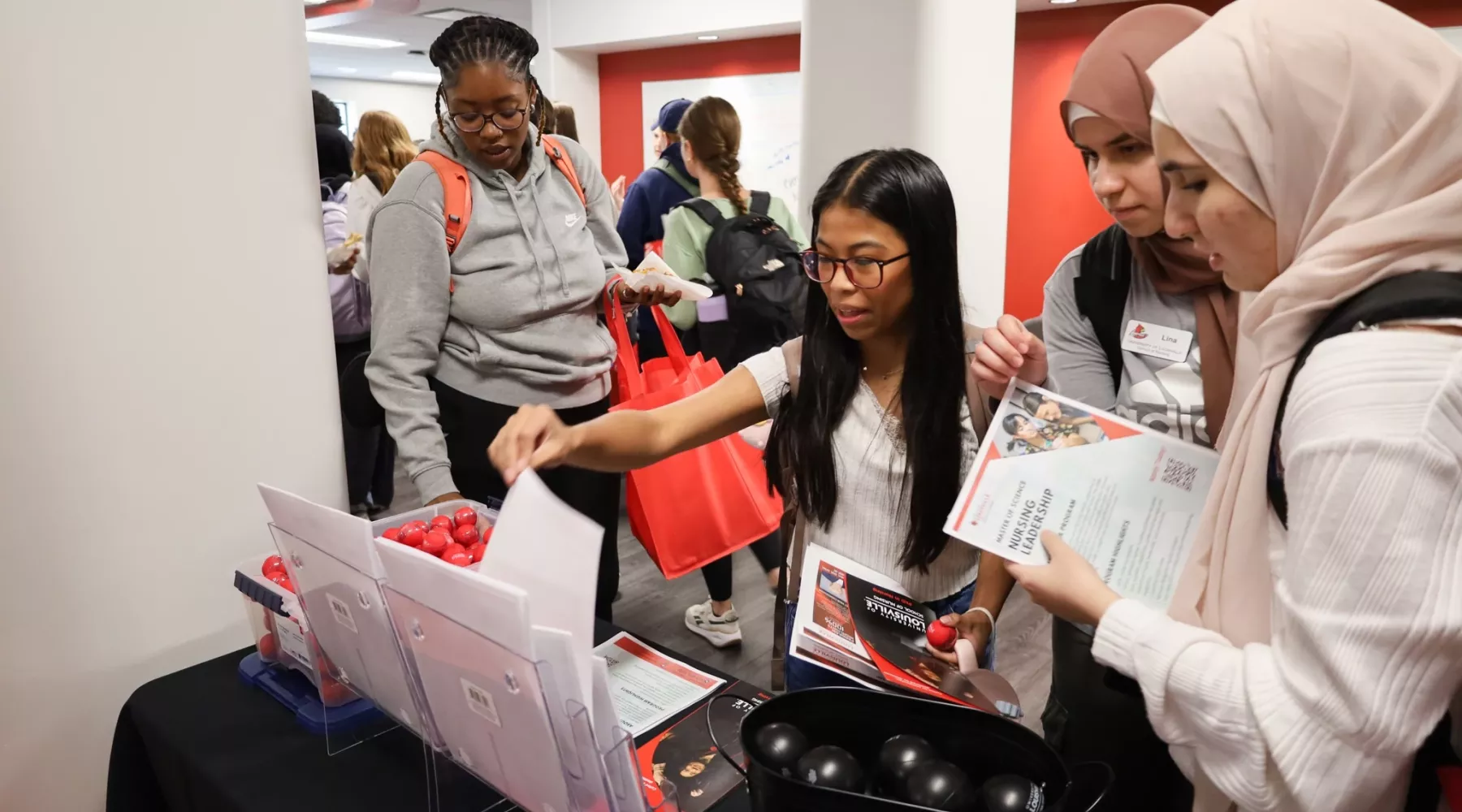 BSN students collect materials during a welcome lunch.