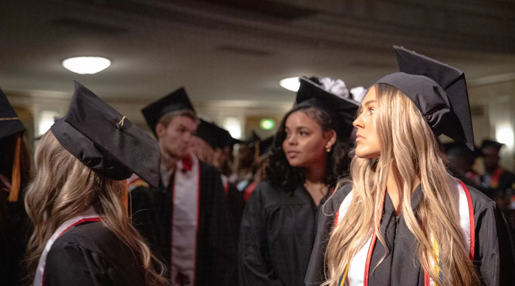 2024 winter Convocation ceremony for UofL School of Nursing graduates at the Brown theater. Graduates stand to leave at the end of the ceremony. They look on to their hopeful future.