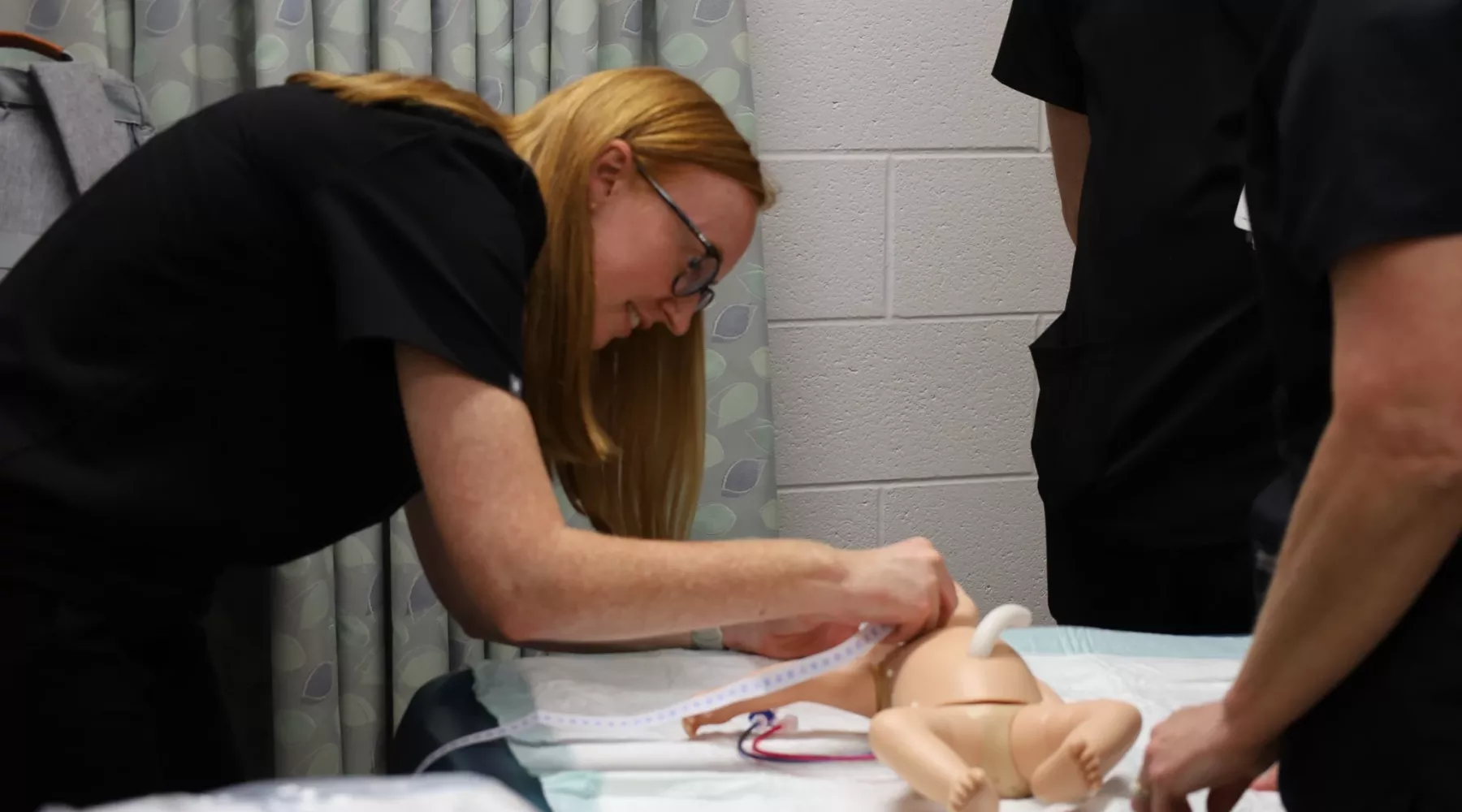 Nursing student performs neonatal simulation.