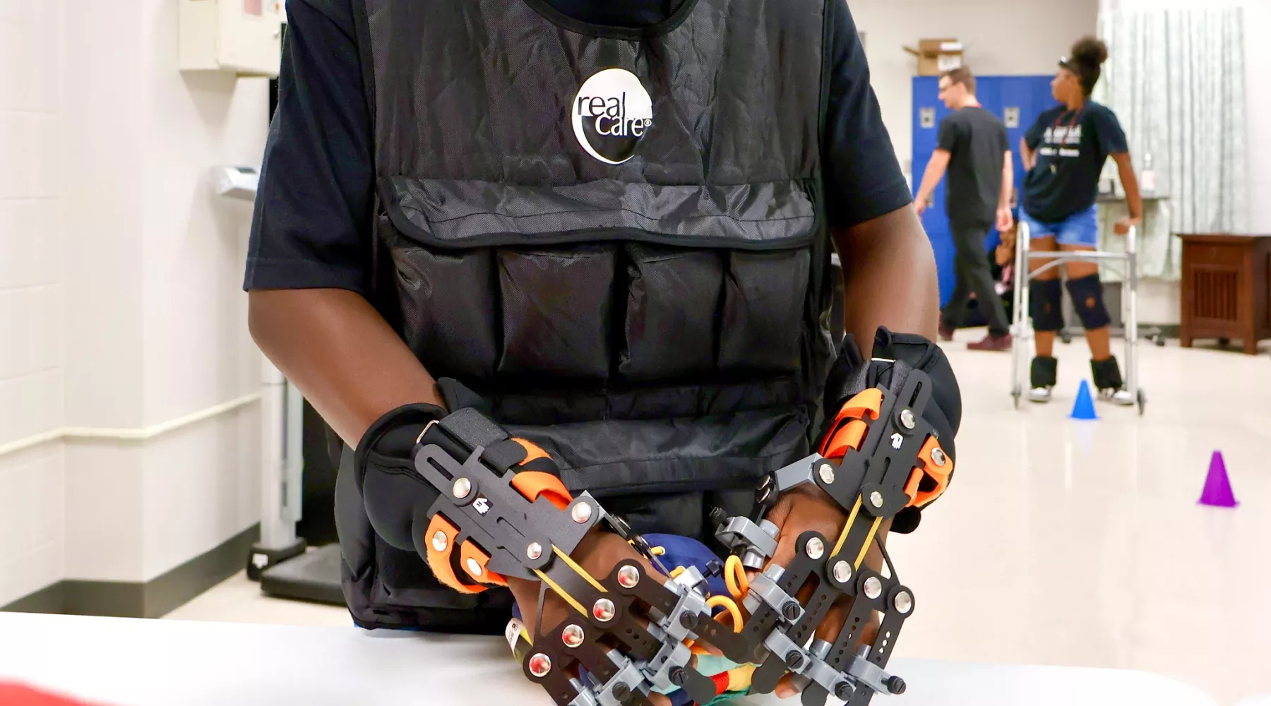 University of Louisville School of Nursing Healthcare Hero high school student wears mobility-restricting gloves to learn about the difficulties patients might face.