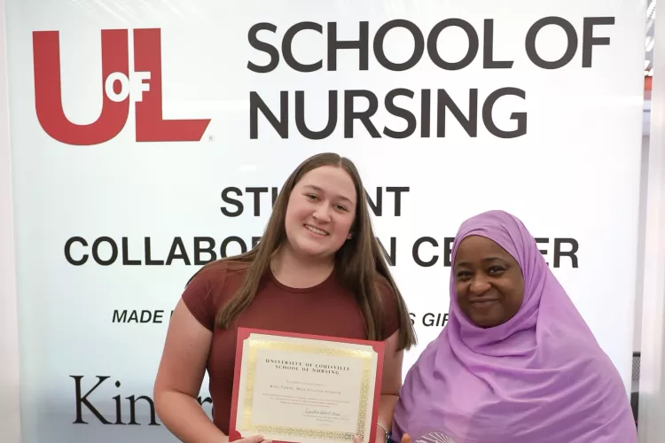 High school student and participant in the Path Ahead Summer Bridge Program at the University of Louisville School of Nursing, Kira Tudor, accepts her certificate of completion from program director, Cynethia Bethel-Hines.