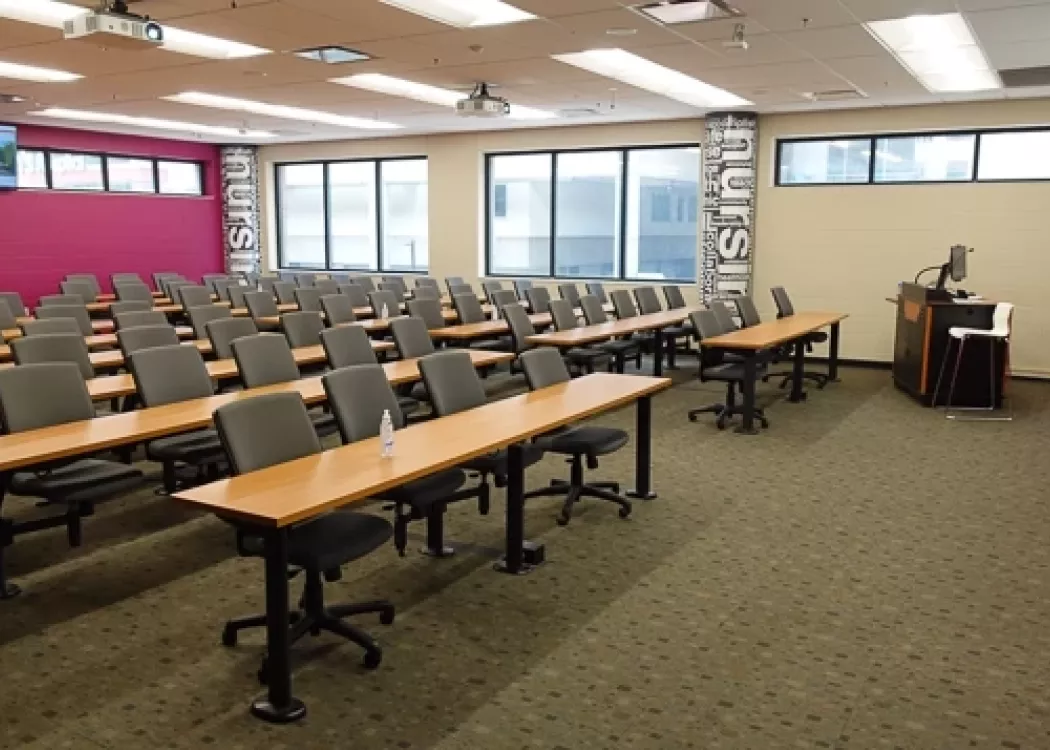 Image of an empty lecture style classroom 2003 in the KWing Nursing building.