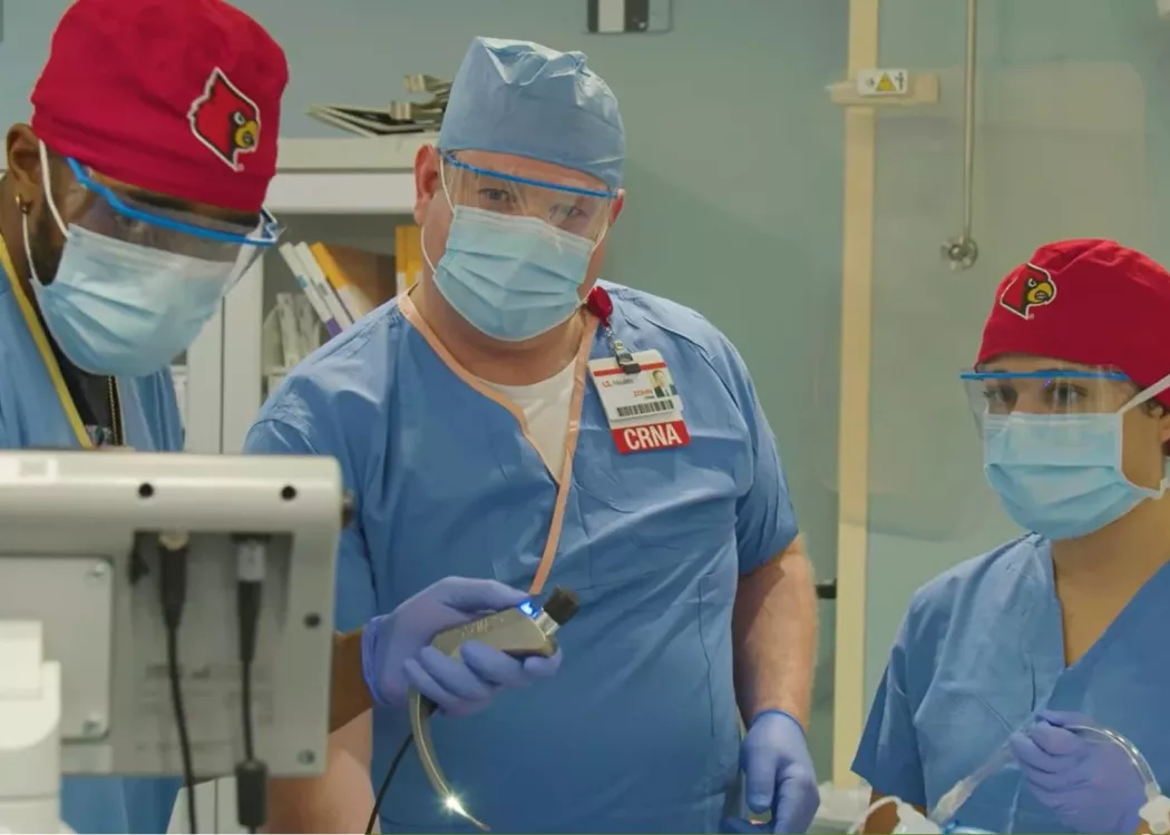 Dr. Zohn Centimole providing instruction to two Nurse Anesthesia residents in a simulation setting.