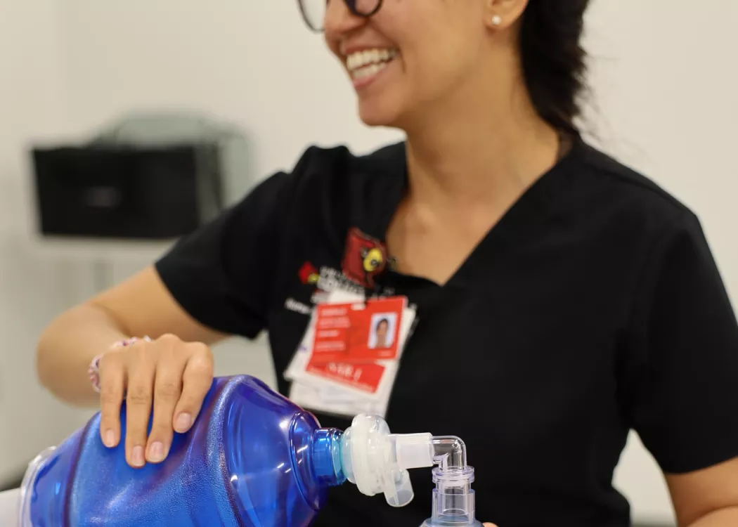 Nurse anesthesia student performing manual ventilation on a simulation manikin.
