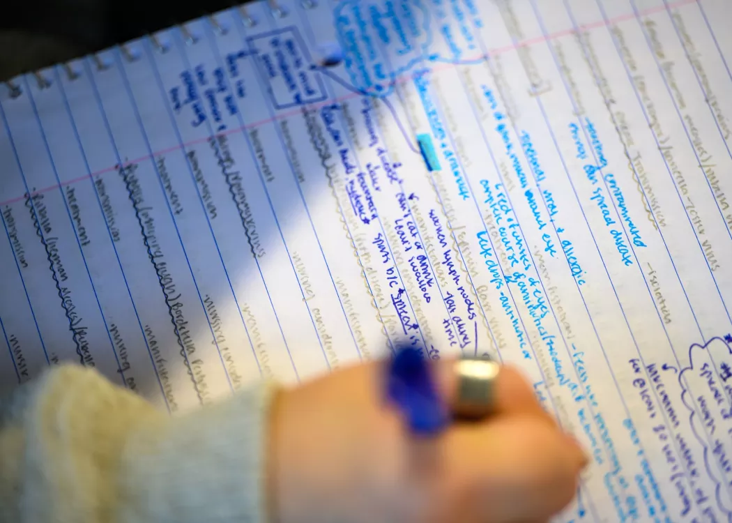 Students in a nursing lecture listening and taking notes.