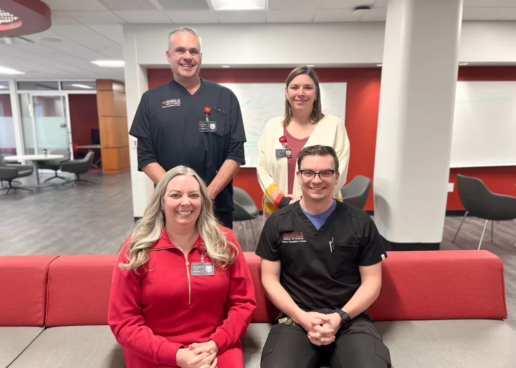 University of Louisville School of Nursing faculty and staff simulation team post for a photo in the Student Collaboration Center. Simulation Center Director Chris Pennington, Brett Kendon, Cristin Whitaker, and Mark Stewart are pictured.