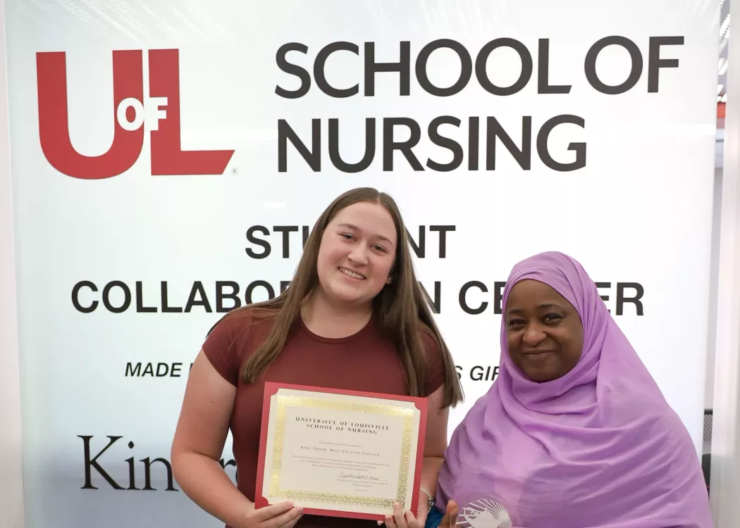 High school student and participant in the Path Ahead Summer Bridge Program at the University of Louisville  School of Nursing, Kira Tudor, accepts her certificate of completion from program director, Cynethia Bethel-Hines.