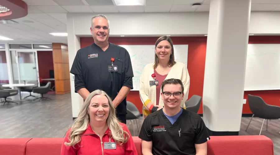 University of Louisville School of Nursing faculty and staff simulation team post for a photo in the Student Collaboration Center. Simulation Center Director Chris Pennington, Brett Kendon, Cristin Whitaker, and Mark Stewart are pictured.